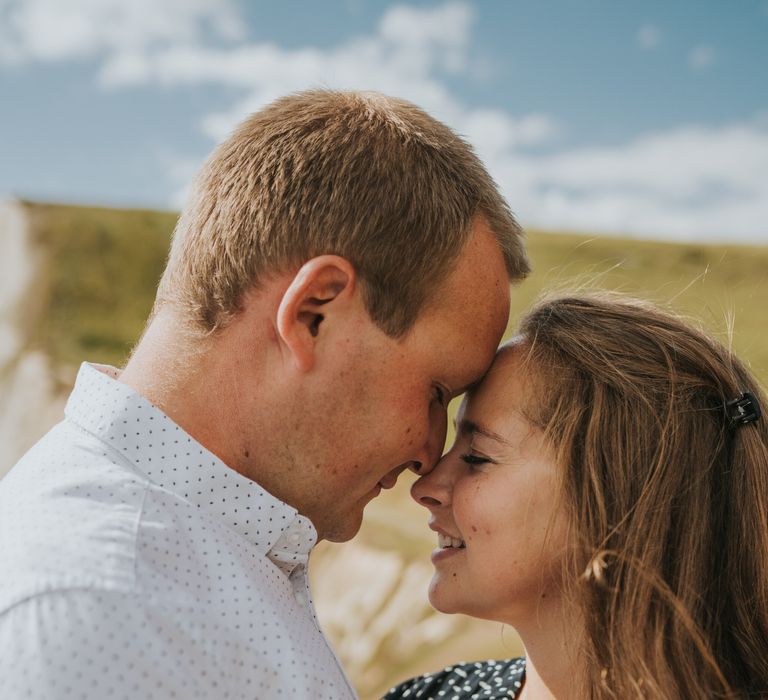 Newly engaged couple engagement shoot in Dorset by the coast