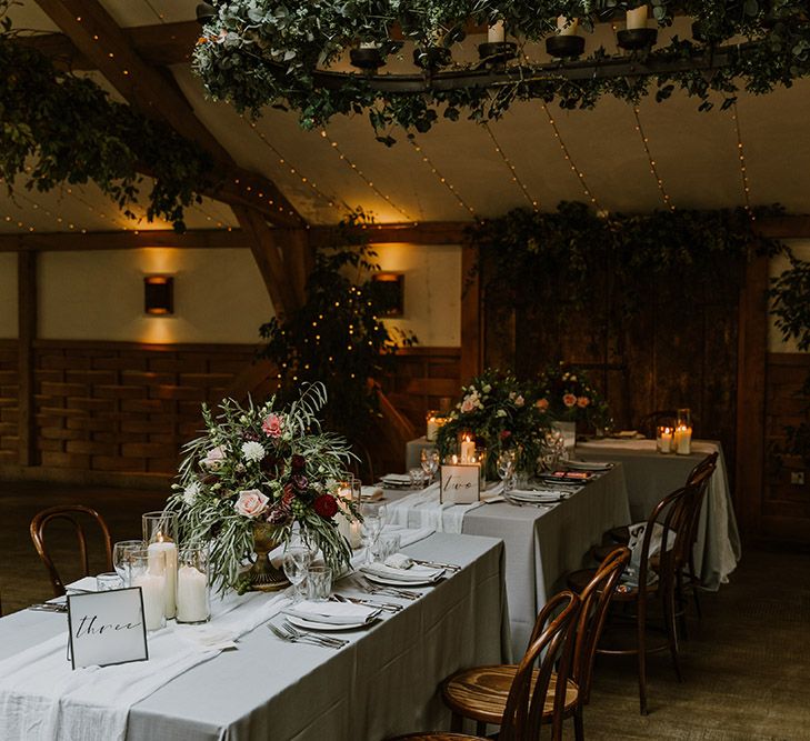 Socially distanced wedding breakfast with fairy lights and foliage wedding decor 