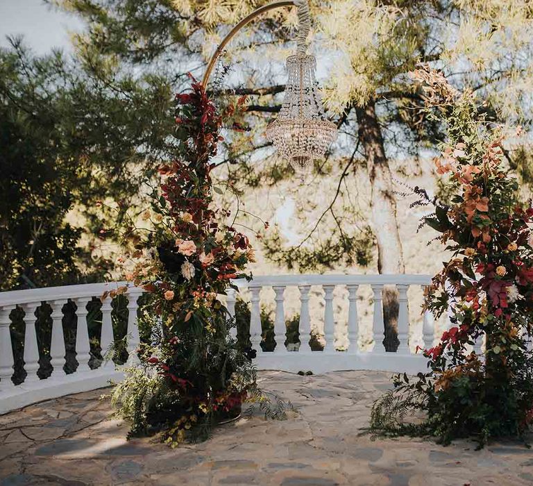 Autumn coloured wedding flowers arch for elopement