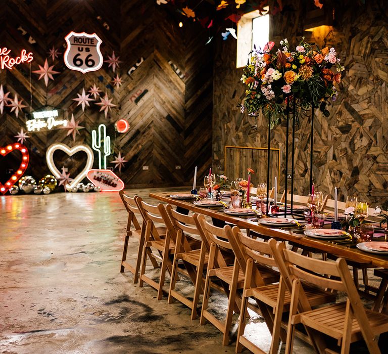 Colourful eclectic wedding decor with neon wedding signs, bright flowers and tableware 