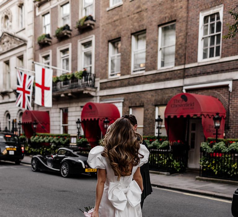 Giant bow wedding dress detail on short wedding dress for stylish city wedding 