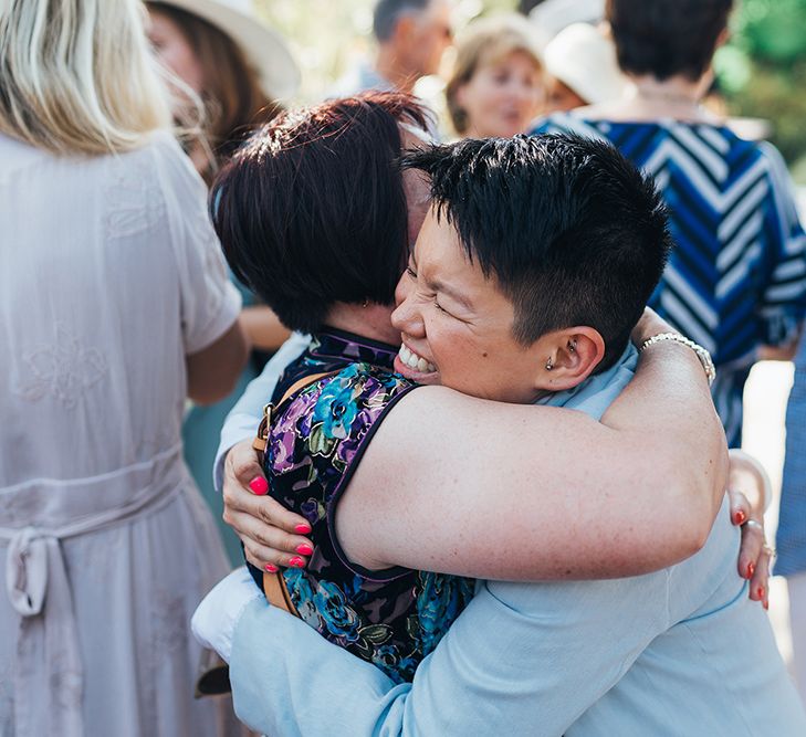 Bride hugs wedding guest on her wedding day