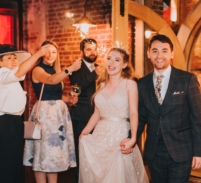 Sparkler moment at rustic wedding with bride in an embellished tulle wedding dress and bridal crown 