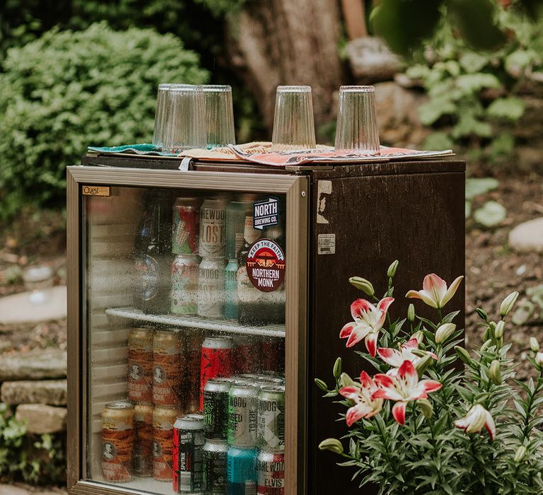 Miniature fridge at back garden wedding with craft beers