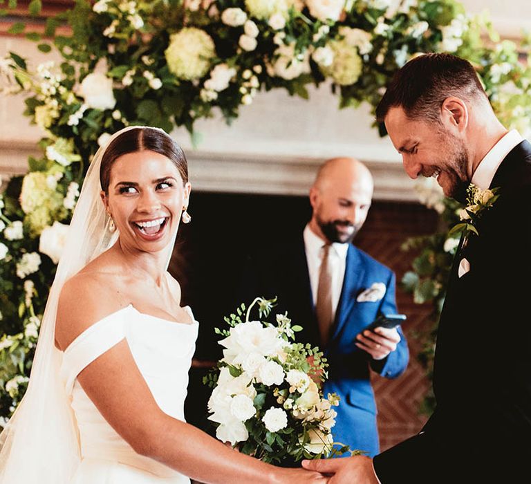 Bride & groom stand together during their wedding ceremony