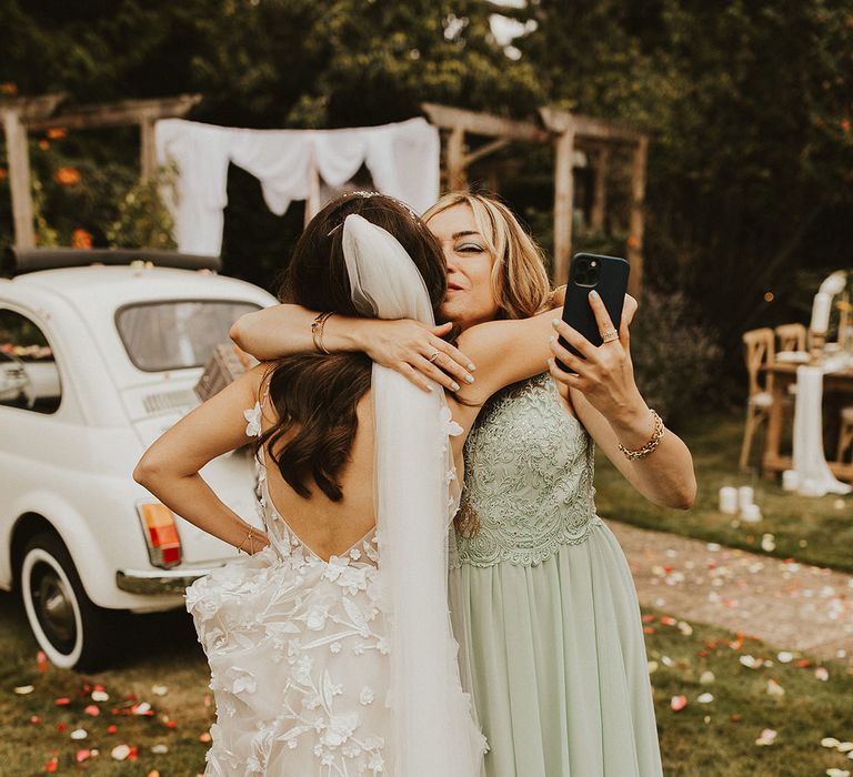 Bride hugs wedding guest on her wedding day