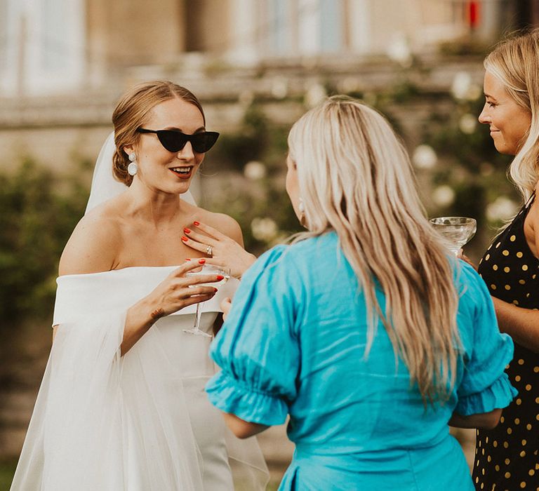 Bride wears sunglasses outdoors on her wedding day