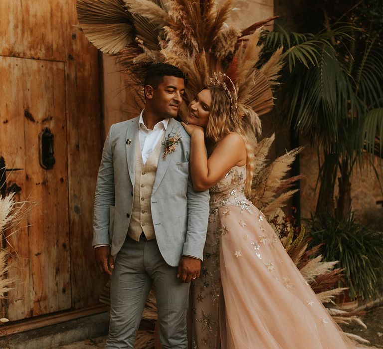 Bride leans in to groom on her wedding day