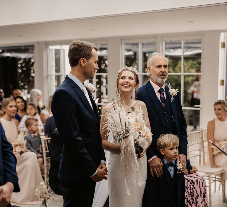 Bride looks lovingly at her husband during wedding ceremony