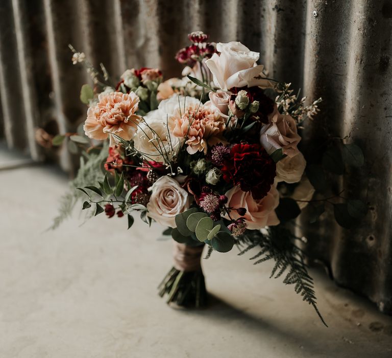 Wedding bouquet with caramel Carnations, Astrantia, waxflower, chocolate Lisianthus and reflexed Menta Roses