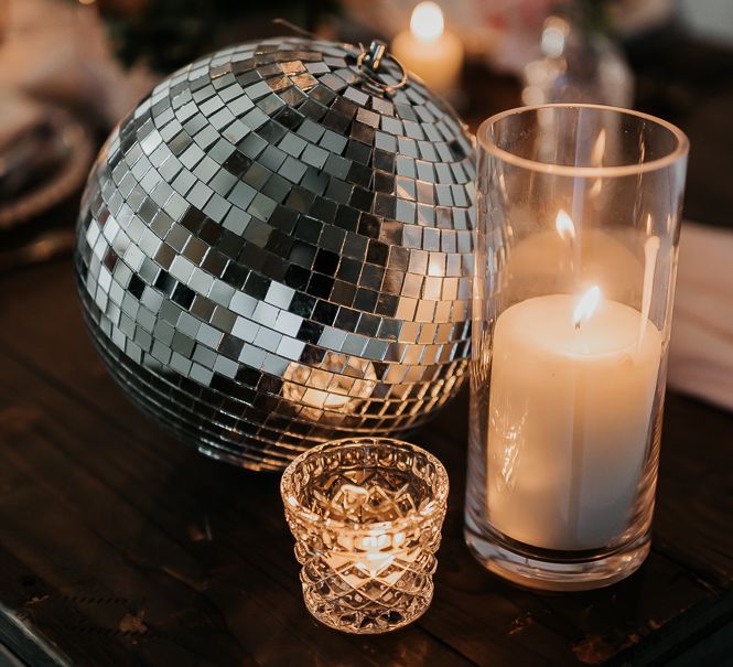 Pillar candles next to disco balls