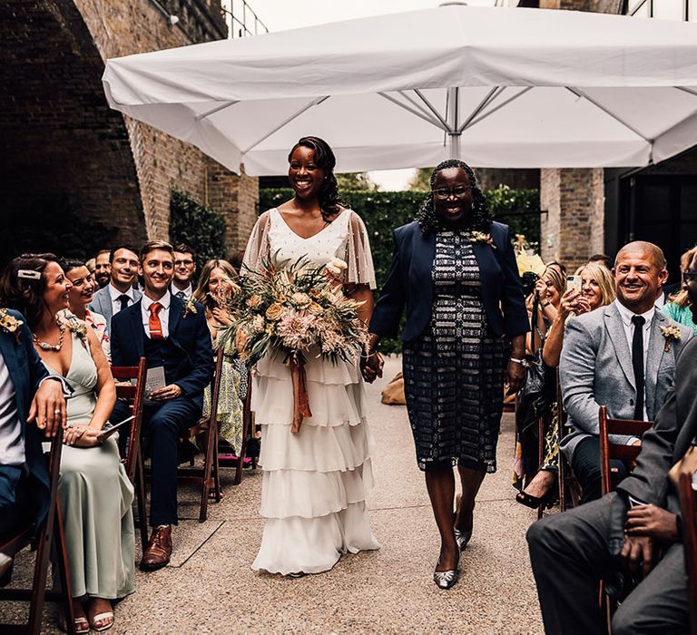 Mother of the bride walking her daughter down the aisle at 100 Barrington wedding ceremony