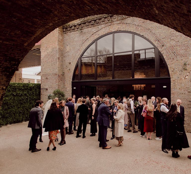 Wedding guests congregate at industrial city wedding venue in Brixton