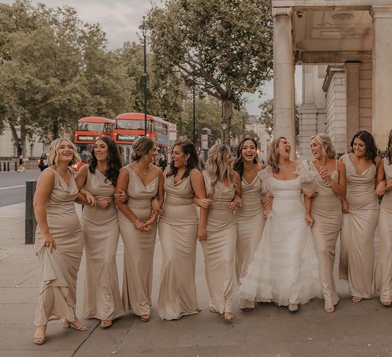 Bride in ruffle Halfpenny London wedding dress with all her bridesmaids in champagne gold dresses 