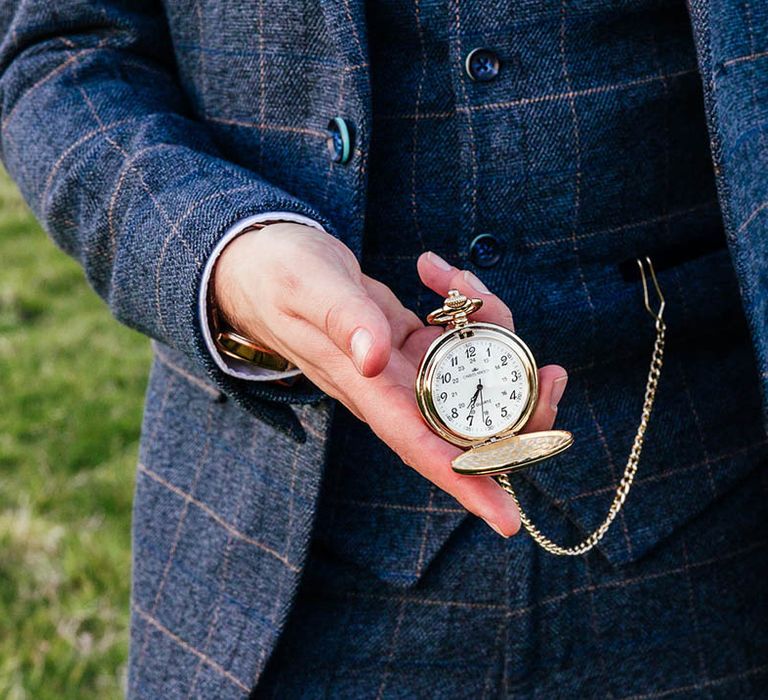 Groom in a blue suit with a gold pocketwatch 