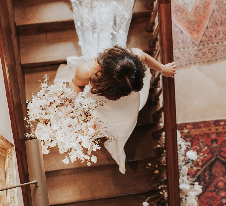 Bride carrying her pretty neutral and pink wedding bouquet with satin Alexandra Grecco wedding dress