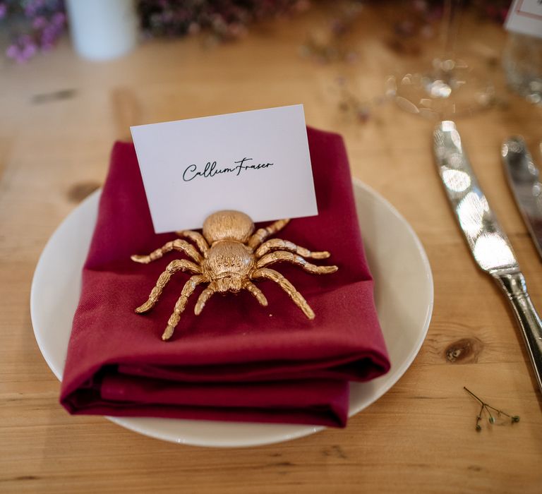 Fabric red napkin complete with spray painted gold animal for DIY place settings 