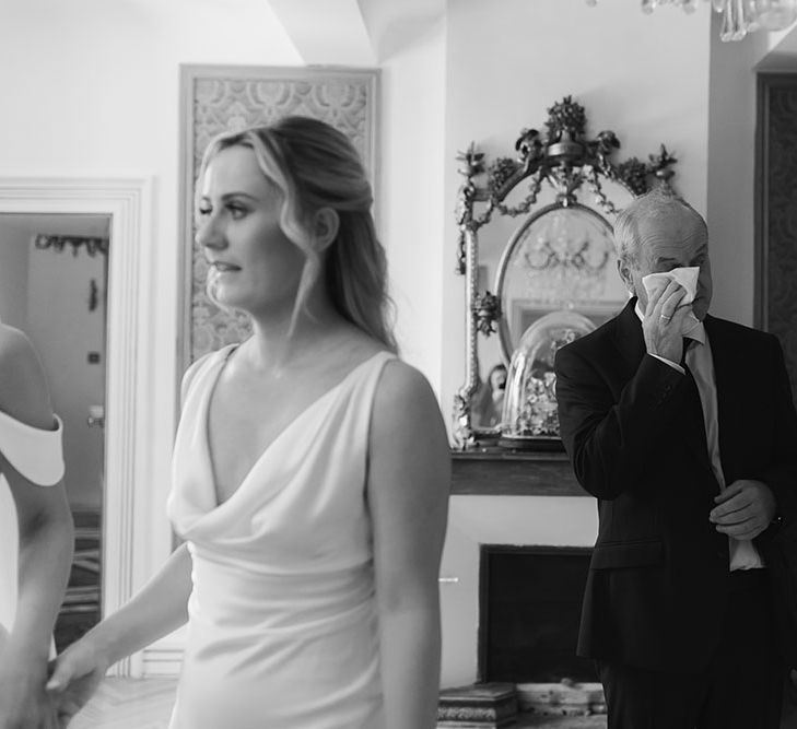 Brides father becomes emotional as he sees bride for the first time on her wedding day in black and white image