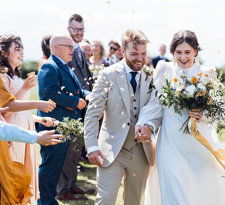 Confetti moment for the bride and groom as they exit from their humanist wedding ceremony 