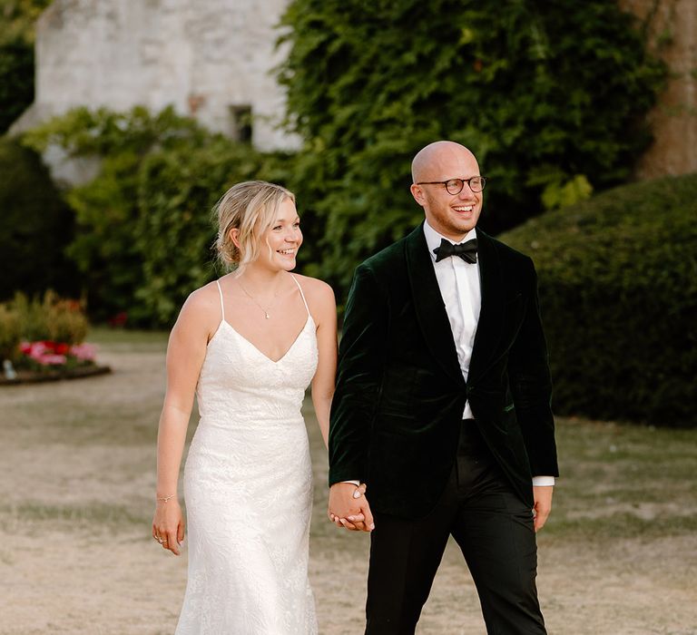 Bride & groom walk outdoors at Bisham Abbey on their wedding day 