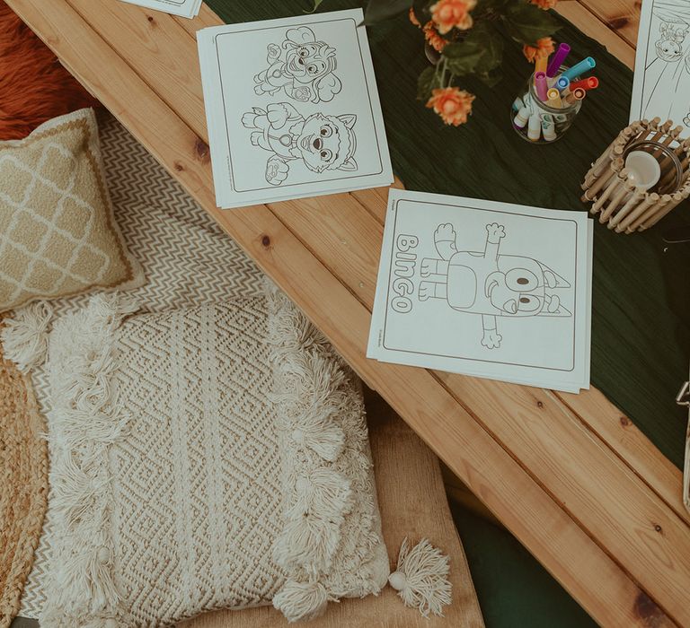 Colouring table for the kids at family-oriented bouncy castle wedding 