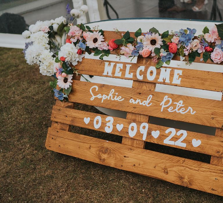 DIY rustic wooden pallet wedding sign with pastel flower decoration 