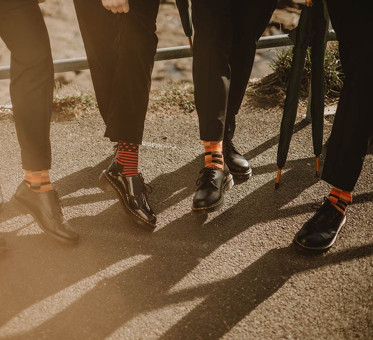 Autumnal orange and black wedding socks worn by groom and groomsmen 