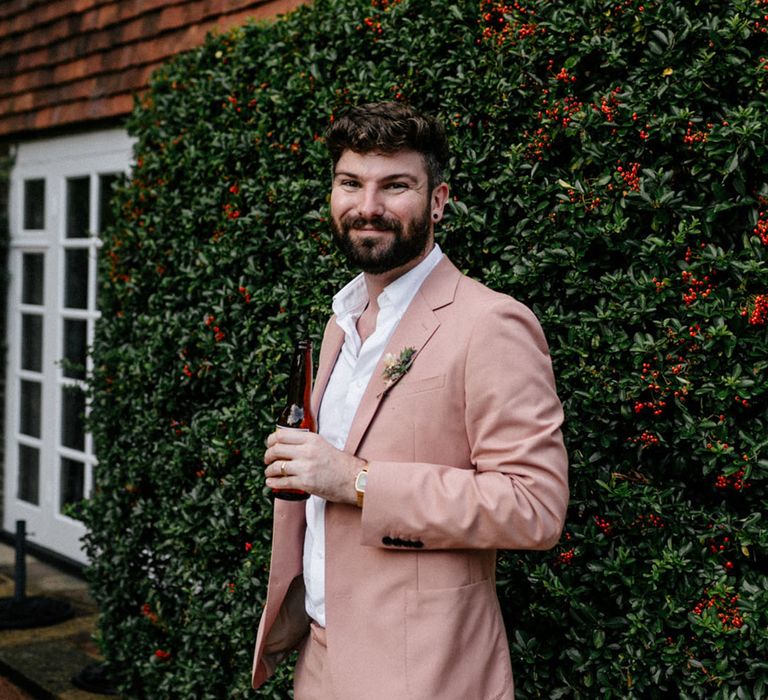 Groom in muted pink wedding suit for town hall wedding in London 