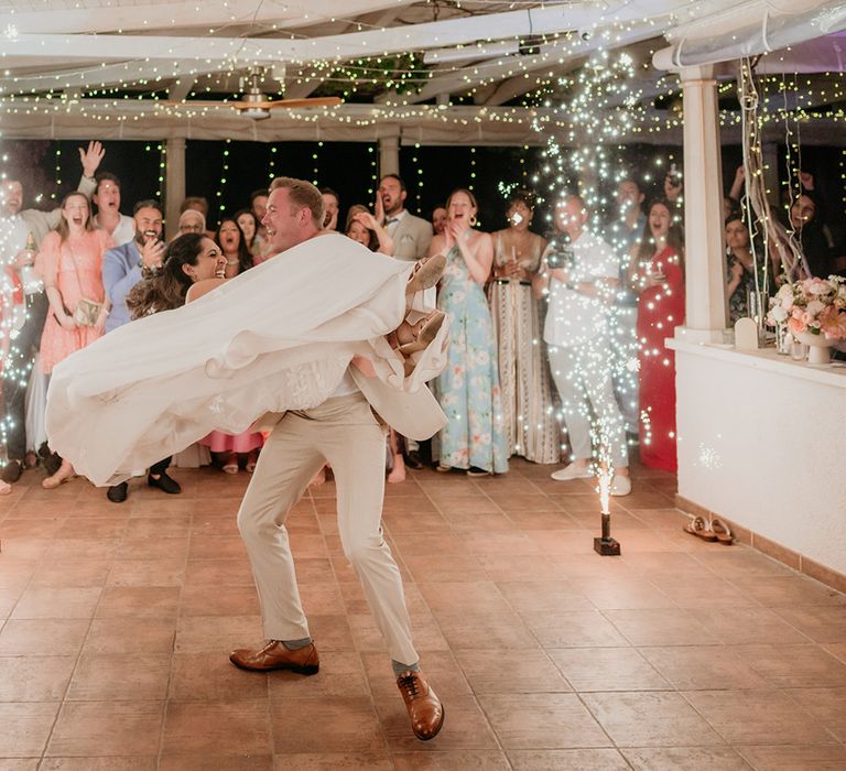 Bride and groom share first dance at Reataurant Park Hvar with large sparklers 