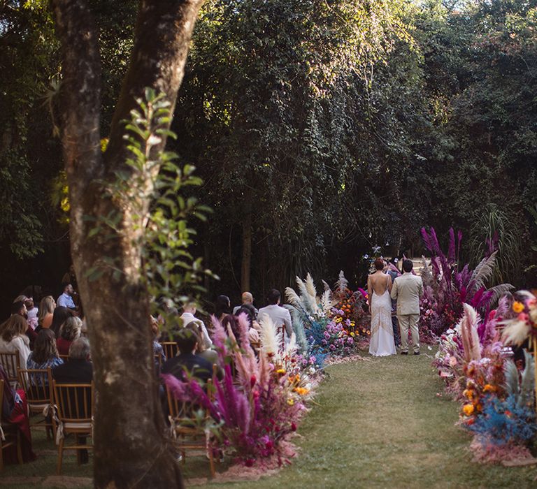 Villa Mandacarú in Brazil wedding venue with outdoor ceremony with colourful dried wedding flowers decorating the aisle and altar 