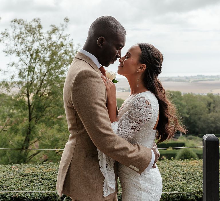 The bride and groom pose for a stunning couple portrait together 