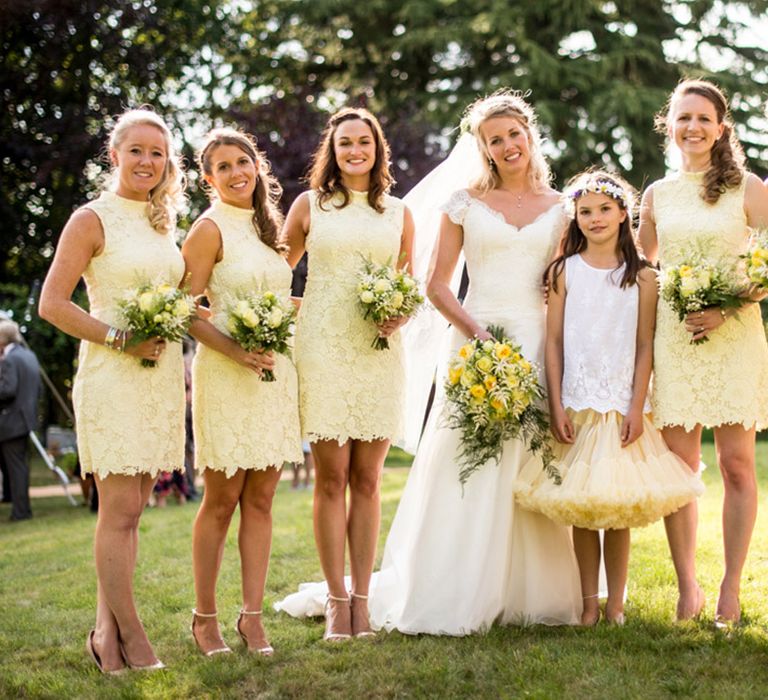 Bridesmaids wearing high neck sleeveless short lace yellow bridesmaid dresses 