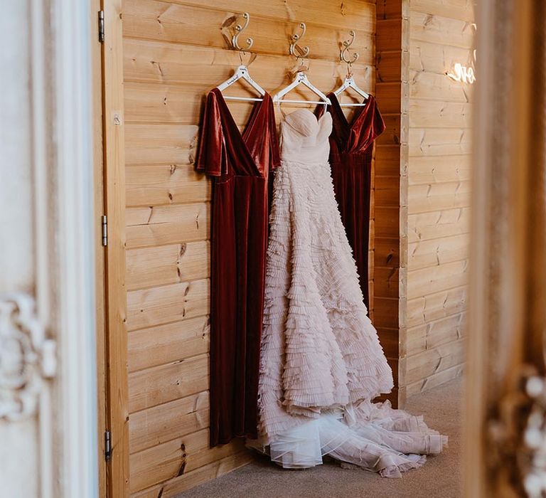 Personalised white hangers with velvet bridesmaid dresses for autumn wedding with strapless ruffle wedding dress from Recycle My Wedding