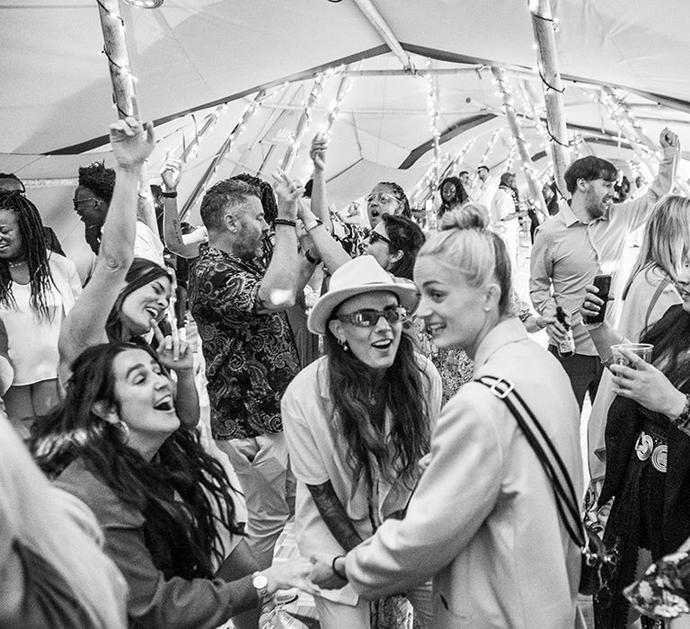 Tipi festival wedding reception with guests dancing to the music 