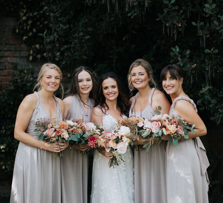 Bridal party portrait with bridesmaids in dusky pink dresses 