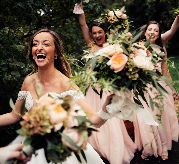 Wedding party celebrating at October barn wedding with beach bridesmaids dresses