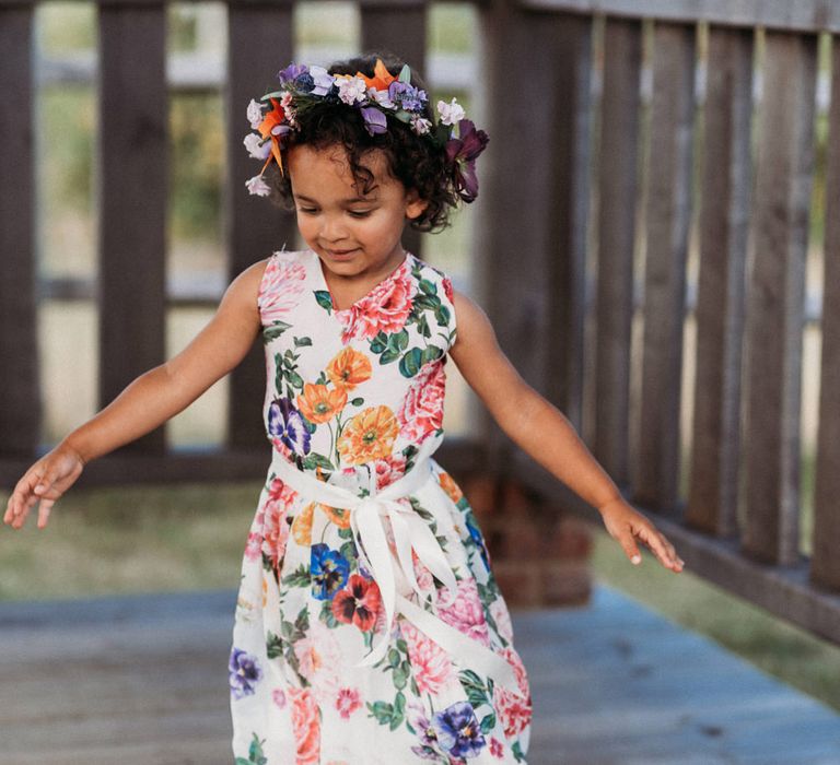 Little girl in floral wedding dress and crown 