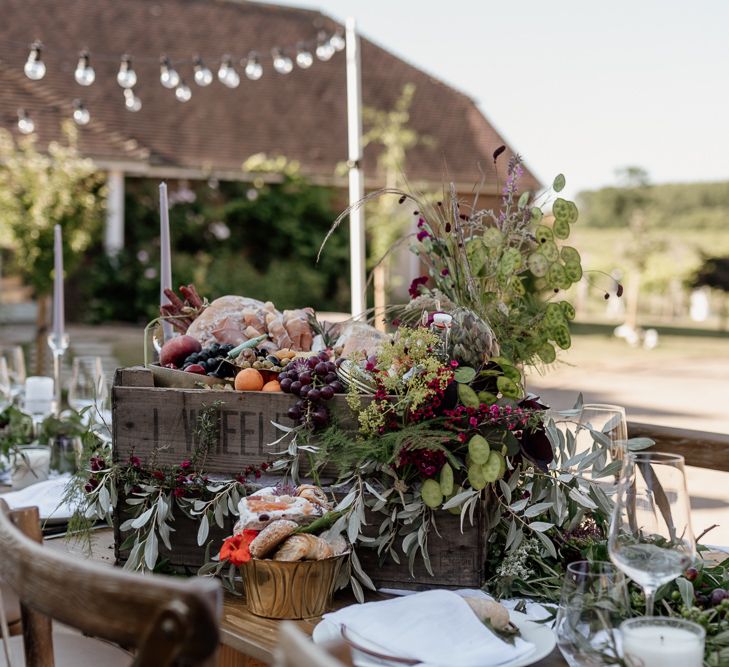 Outdoor wedding reception with crate of anti pasti wedding food 