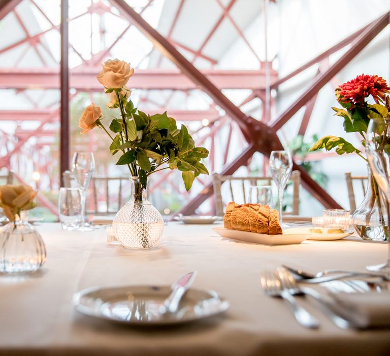 Glass centrepiece vase with flower stems 