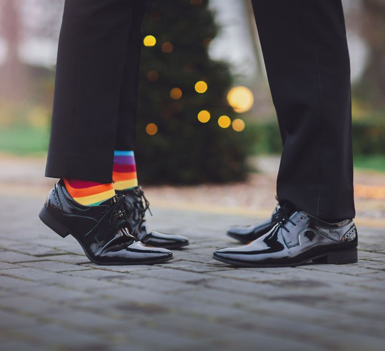 Grooms in patent shoes and multicoloured rainbow socks 