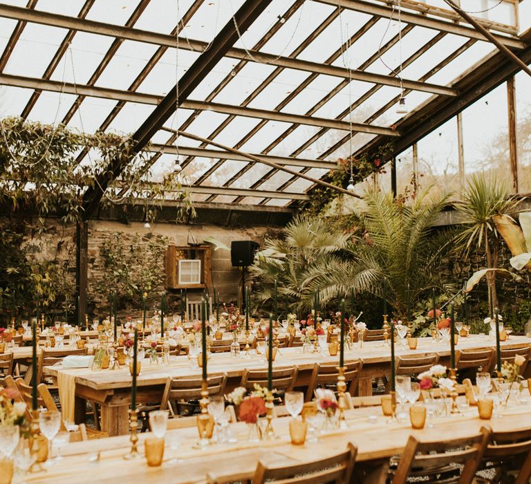 Moroccan and, autumn themed glasshouse wedding reception at Anran, Devon, with dark green and orange wedding decor 