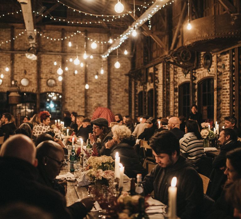 Rustic wedding reception with candles, festoon lights and fairy lights decor 