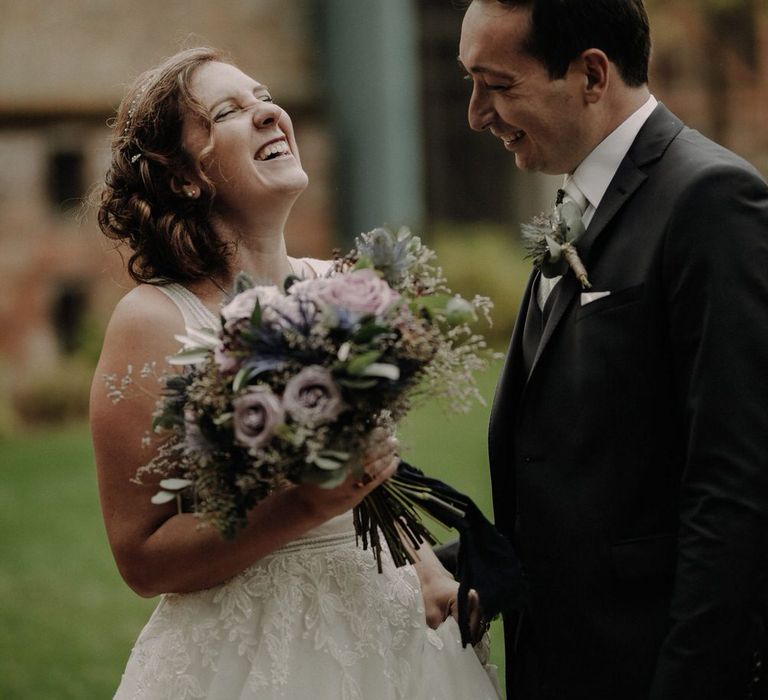 The bride and groom laughing together