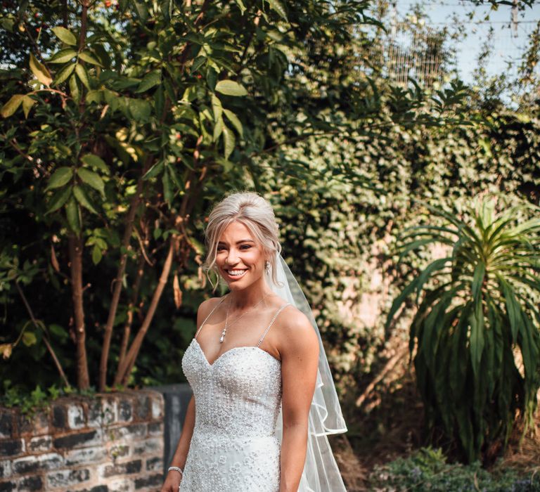 Bride wears sequinned wedding gown 