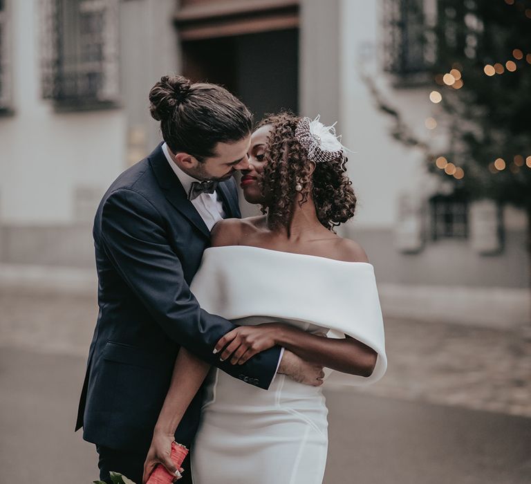 Bride & groom embrace outdoors on wedding day