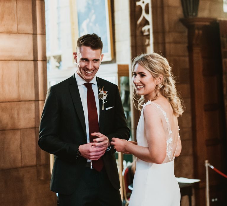 Bride & groom stand together during wedding ceremony