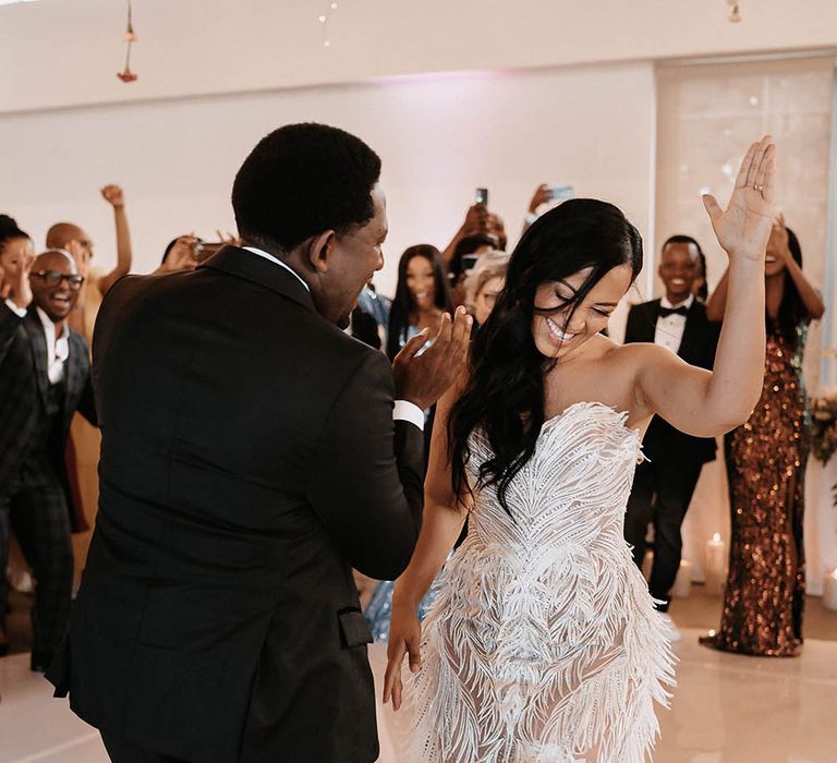 Bride in a strapless Biji La Maison de Couture wedding dress dancing on the dance floor with her groom in a tuxedo 