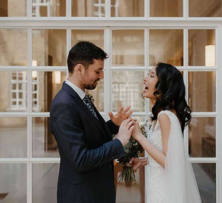 Bride and groom laughing together after their wedding ceremony