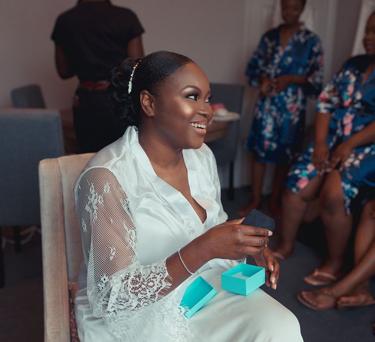 Bride receives Tiffany earrings as wedding gift on her wedding morning