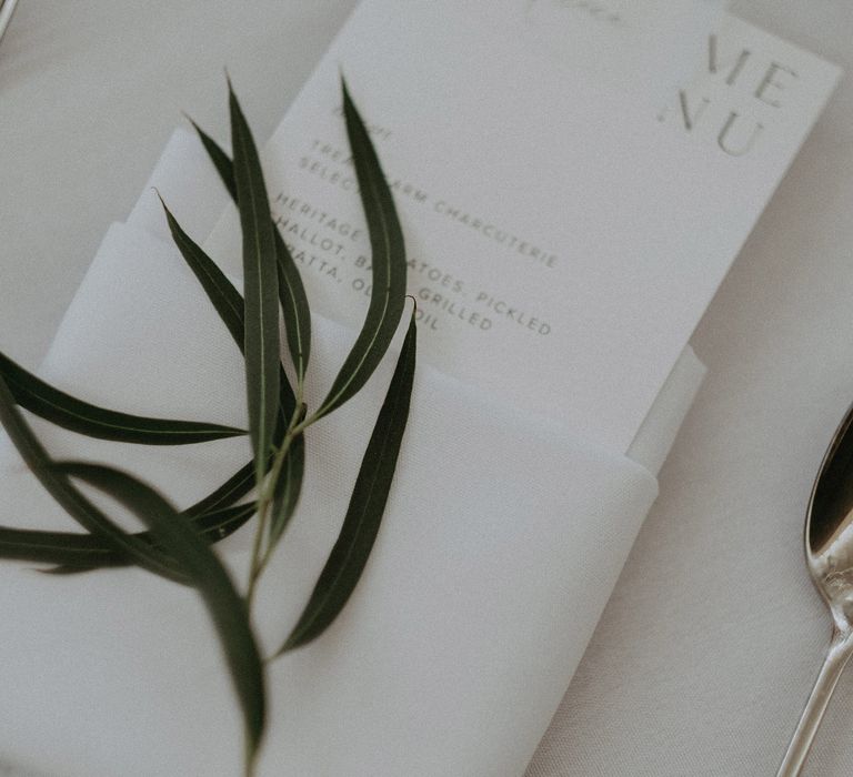 White stationery for reception complete with rosemary decoration